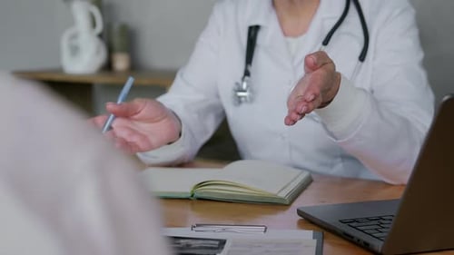 Closeup of a Woman Doctor's Hands During a Patient's Appointment in Her Office