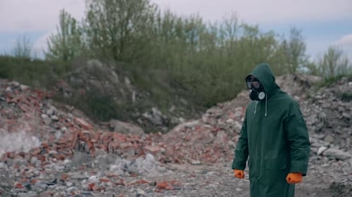 Person in Hazmat Suit Walks Through Ruined Landscape