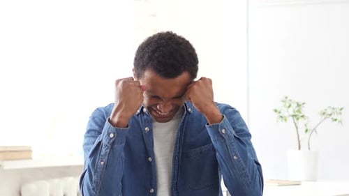 Man Expressing Strong Emotions in Bright Room