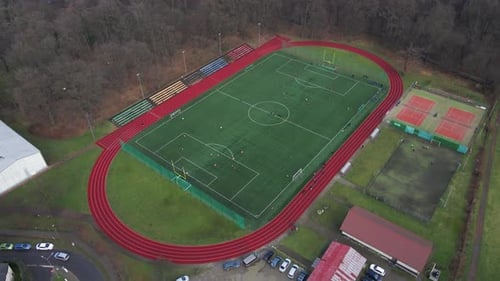 Aerial View of Stadium in Small Town Players Play Football on Soccer Field