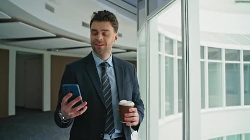 Confident Ceo Checking Phone Walking Office Hallway with Coffee Takeaway Closeup