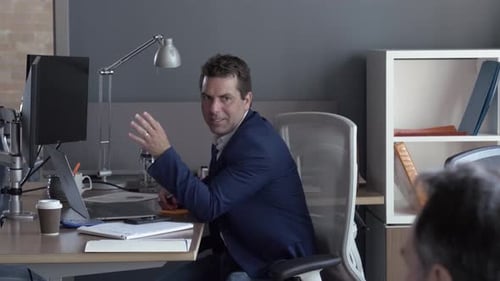 Businessman Talking with Colleague in Office Adult