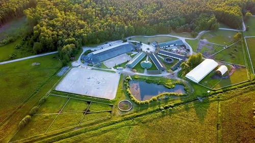 Aerial shot , horses riding in an outdoor arena