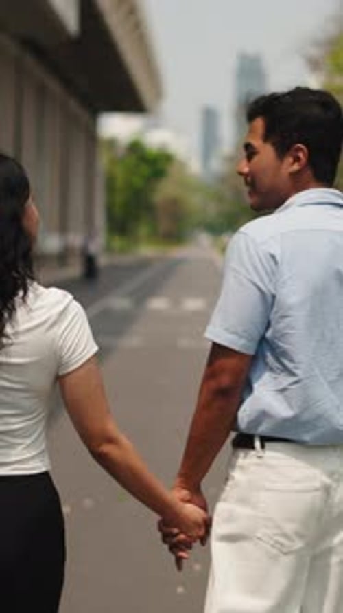 Couple Walking Together Holding Hands in Urban Setting