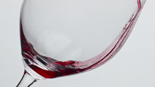 Red Wine Pouring Into Glass Close Up