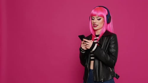 Stylish Woman with Pink Hair Listens to Music