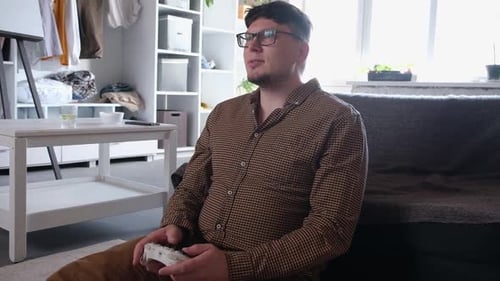 Man Playing Video Games on Controller Indoors