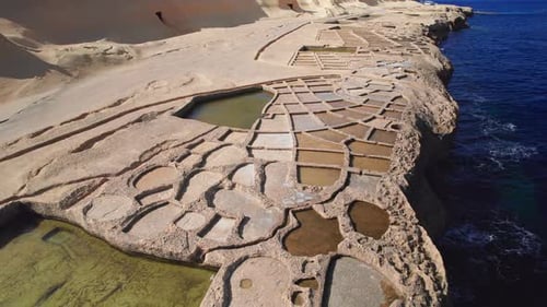 Cinematic Aerial Orbit of Salt Pans, Landmark of Gozo Island, Malta