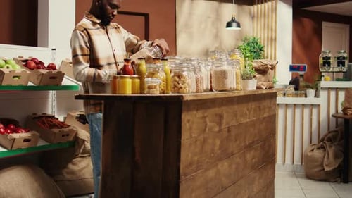 Man Filling Jar at Grocery Store Counter