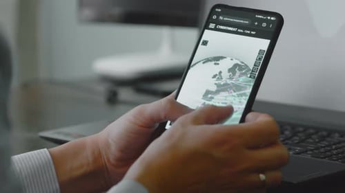 Hands Holding Mobile Phone with Cyberthreat Map