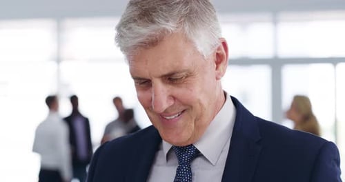 Smiling Businessman in Office With Colleagues