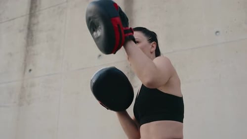 Athletic Woman Boxing with Trainer Outdoors