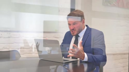 Frustrated Businessman Working on Laptop in Office