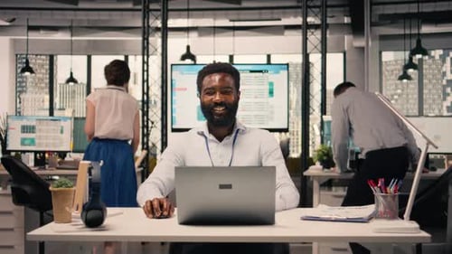 Man Working at Computer in Modern Open Office