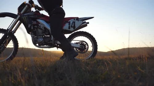Motocross Motorcycle Ready to Drive into Setting Sun