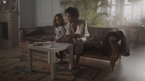 Child and Adult Together on an Ornate Couch