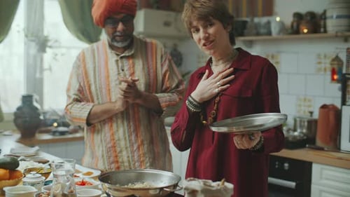 Woman and Man Cooking Together in Kitchen