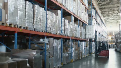 Forklift Loader is Moving Cargo Goods in Logistic Warehouse