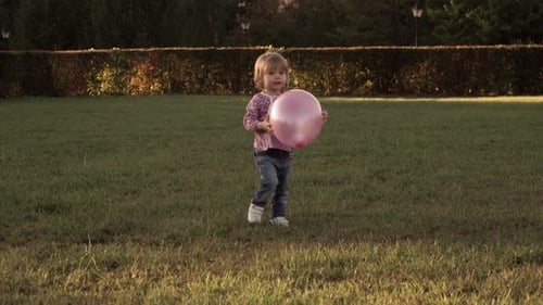 Happy Little Girl Play with Balloon in Summer Park in Evening