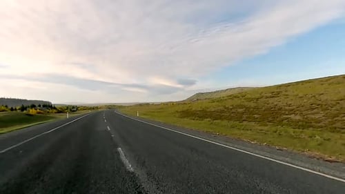 Scenic drive through winding road across open environment on an adventure (slow motion)