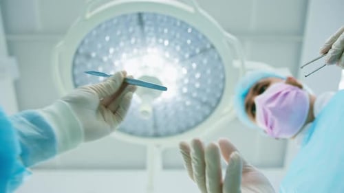 Surgeon Holds Scalpel in Operating Room