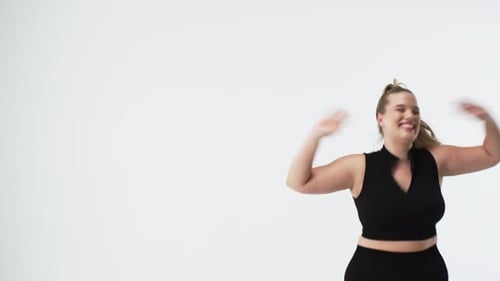 Caucasian beautiful plus size woman smiling and dancing, looking confident and happy, copy space