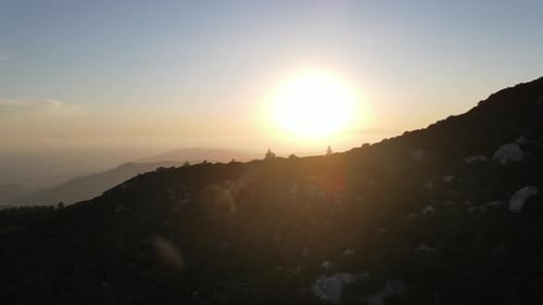 Shore of a bay or river or lake, against the background of the forest, aerial view at sunset