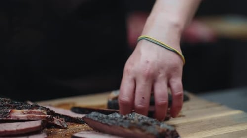 Inside Kitchen Of Meat Restaurant Cook Cutting Well Done Steak On Chopping Board Closeup