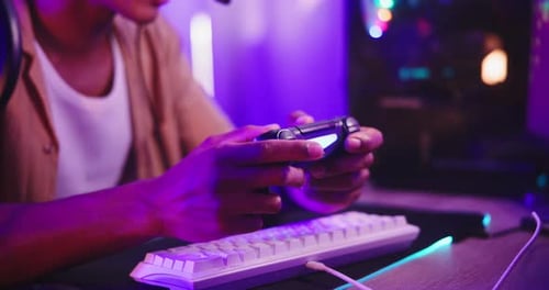 Person Using Video Game Controller with Keyboard