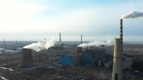 Aerial View of Thermal Power Plant Drone Flies Over Chimney Smoke Pipes and Cooling Towers of