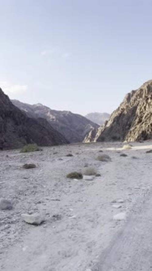 A view of a Mountain in desert from a car on high way, trucking shot