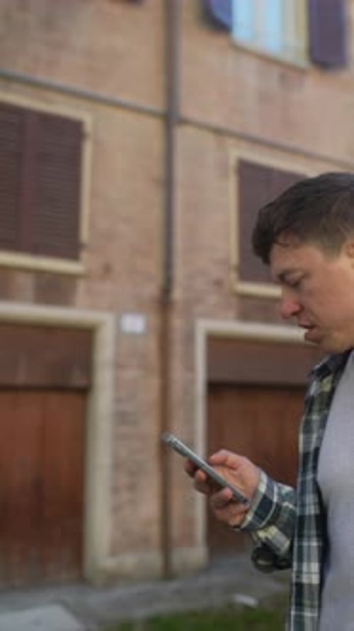 Young Adult Using Phone Outdoors