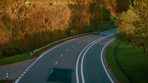 Passenger Car Moving Along Winding Road Between Trees Vehicle Driving Through Curvy Forest Route