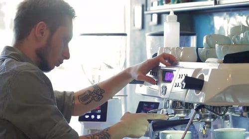 Young Adult Barista Making Espresso at Cafe