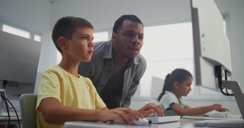 Smart Young Boy Using Computer Doing 3D Design Project Teacher Helping Elementary School Student