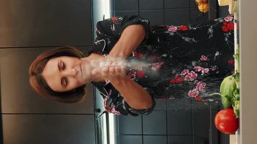 Woman Washing Hands in Modern Kitchen Sink