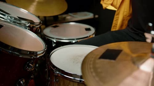 drummer plays a drum kit in a recording studio at a professional musician rehearsal recording a song