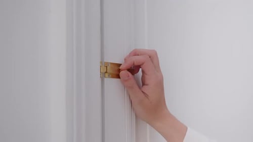 Unlocking white door with simple slide lock, close up