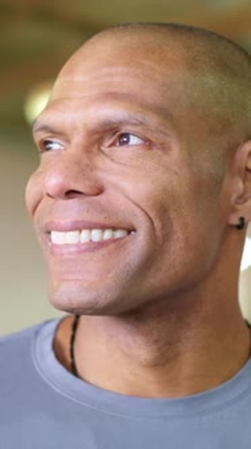 Man Smiling Outdoors in a Close Up Portrait