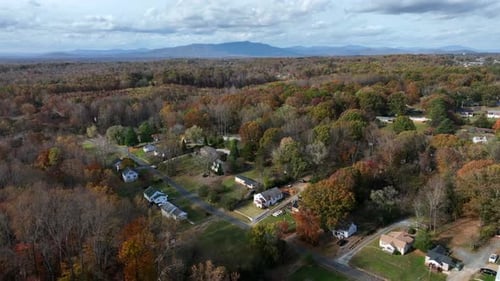 Colored suburb neighborhood in autumn season. Straight street with single family homes and houses. A