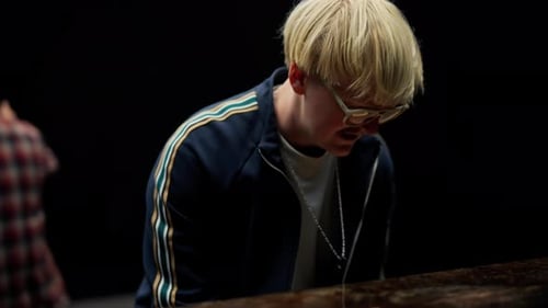 Musician Plays Piano, Man Dances in Background