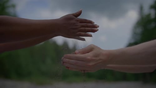 Natural Sand Dropping Into Human Hand in Slow Motion