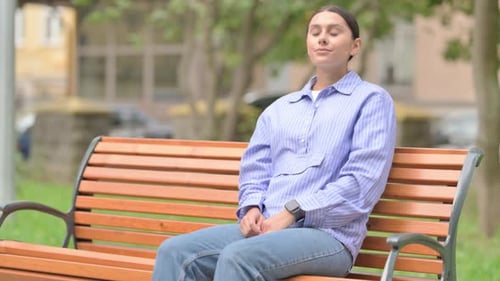 Woman Sitting on Park Bench Checking Her Watch