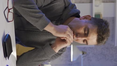 Man Counting Money Appears Stressed and Worried