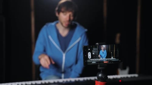 Man Plays Electronic Keyboard for Video Recording