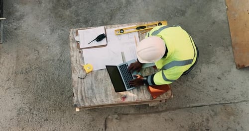 Construction site, laptop and above of man for planning, building design and inspection