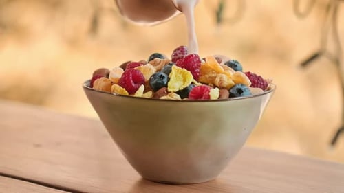 Milk Pouring into Bowl of Cereal and Berries