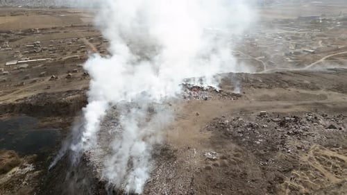 Aerial view of landfill with burning trash piles