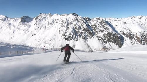 Thrilling Descent High Speed Skiing Down a Perfectly Groomed Snowy Mountain Slope