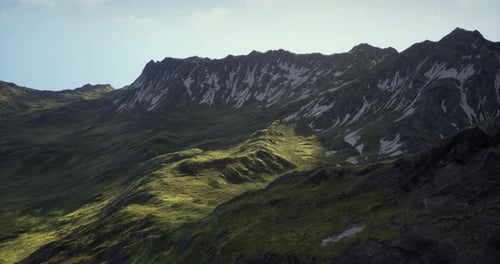 Lush Green Mountains Showcasing Rugged Cliffs and Bright Sunlight in Nature